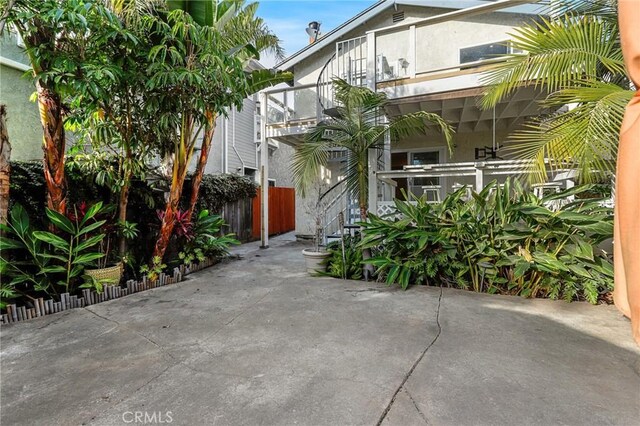 view of front of home with a balcony and a patio area