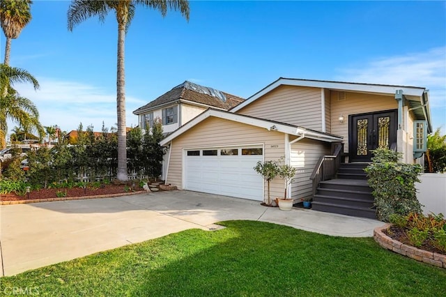 view of front of property with french doors, a garage, and a front yard