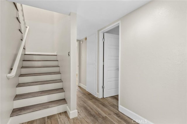 stairs featuring wood-type flooring