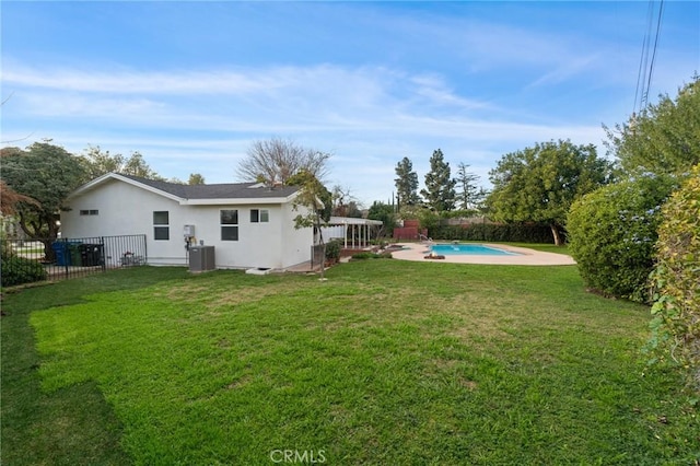 view of yard featuring cooling unit and a fenced in pool