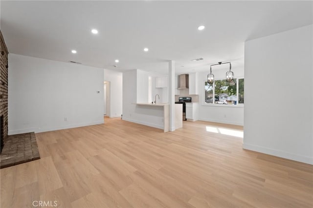 unfurnished living room featuring light hardwood / wood-style flooring and a fireplace