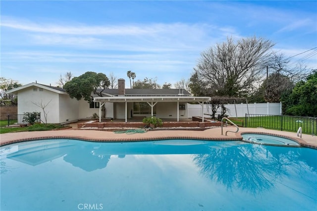 view of swimming pool with a jacuzzi and a patio