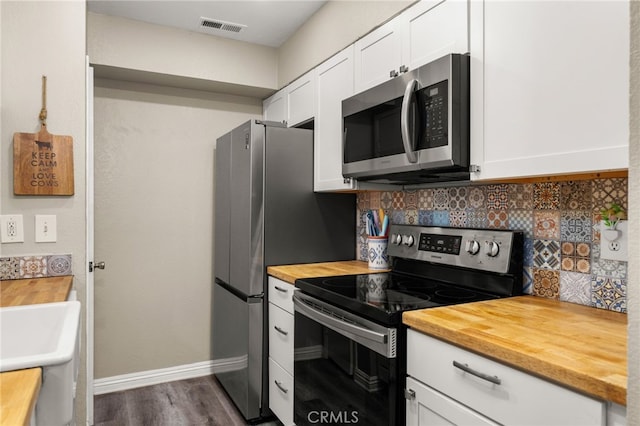 10655 Lemon Ave Unit 3706, Rancho Cucamonga, CA 91737 - kitchen featuring appliances with stainless steel finishes, butcher block counters, baseboards, white cabinetry, and tasteful backsplash