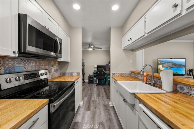 10655 Lemon Ave Unit 3706, Rancho Cucamonga, CA 91737 - kitchen featuring stainless steel appliances, wooden counters, wood finished floors, and white cabinets