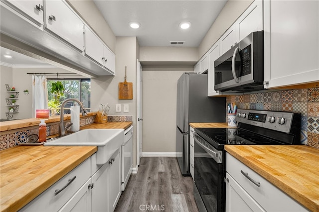 10655 Lemon Ave Unit 3706, Rancho Cucamonga, CA 91737 - kitchen with wooden counters, appliances with stainless steel finishes, backsplash, white cabinets, and dark wood-type flooring