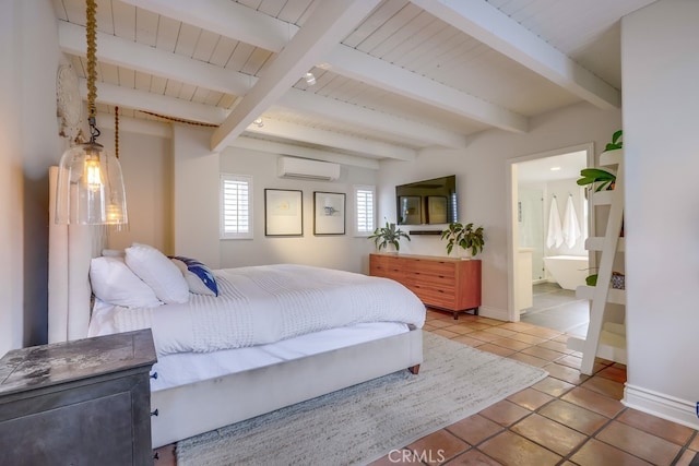 bedroom featuring ensuite bath, beam ceiling, a wall mounted AC, and tile patterned flooring