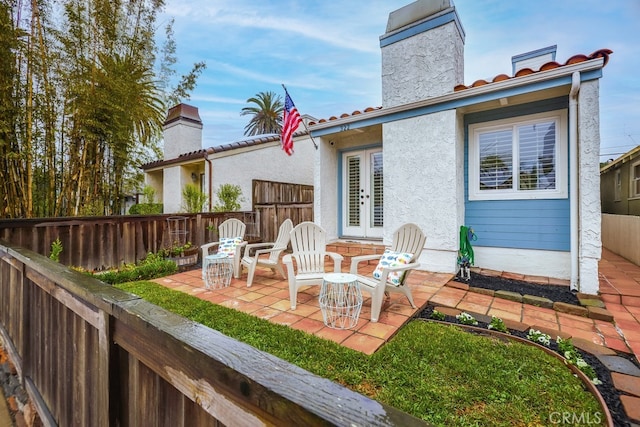 rear view of house with a patio and french doors