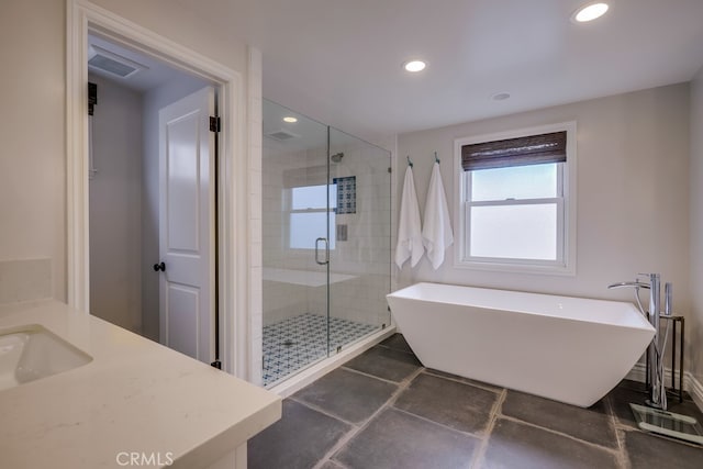 bathroom featuring plus walk in shower and vanity