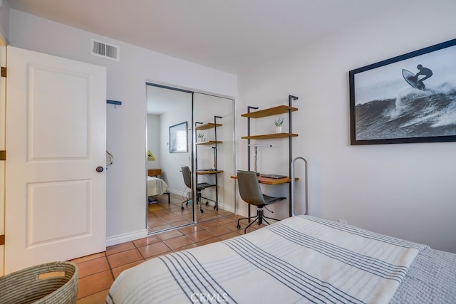 bedroom with light tile patterned flooring and a closet