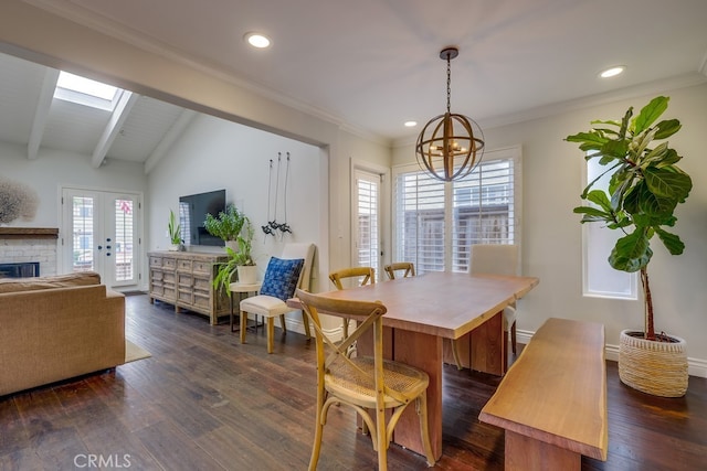 dining space with crown molding, an inviting chandelier, a skylight, dark hardwood / wood-style floors, and beamed ceiling