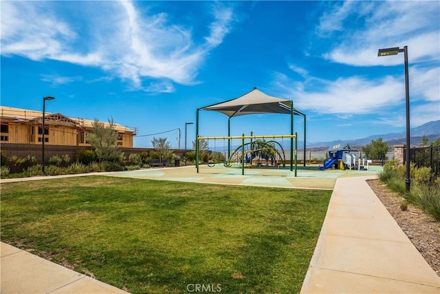 community playground with a yard and a mountain view