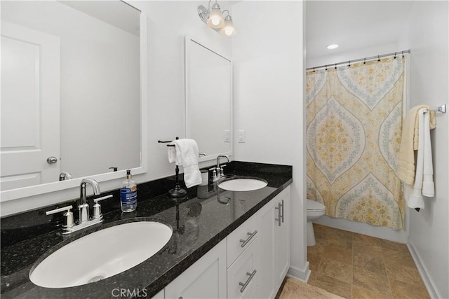 full bathroom with curtained shower, double vanity, toilet, and a sink