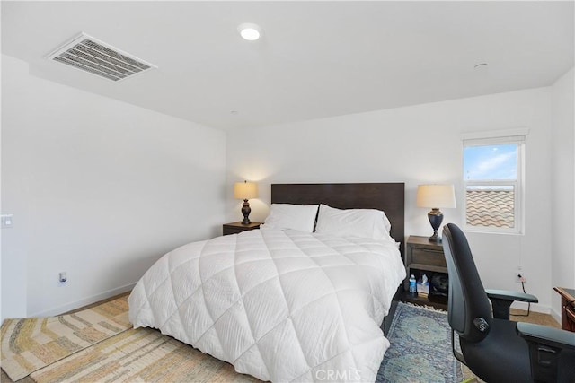 bedroom with visible vents and baseboards