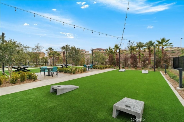 view of home's community featuring a yard and fence