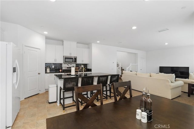 dining space with visible vents, recessed lighting, and stairs