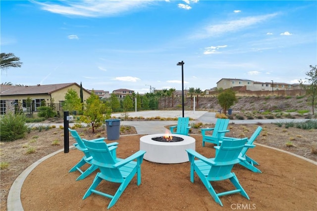 view of play area with fence and an outdoor fire pit