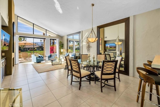 tiled dining area featuring lofted ceiling