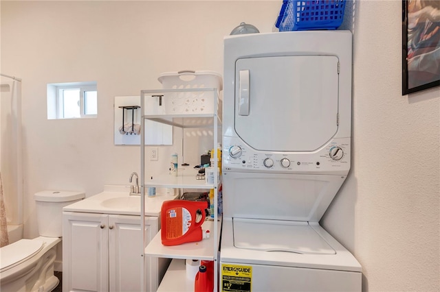 laundry area featuring sink and stacked washer / drying machine