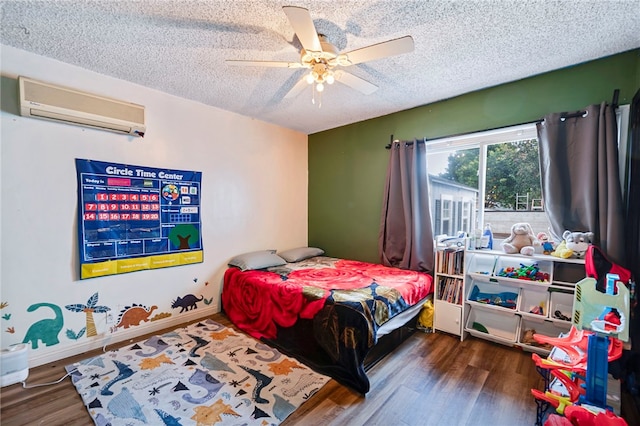 bedroom with an AC wall unit, ceiling fan, dark hardwood / wood-style flooring, and a textured ceiling