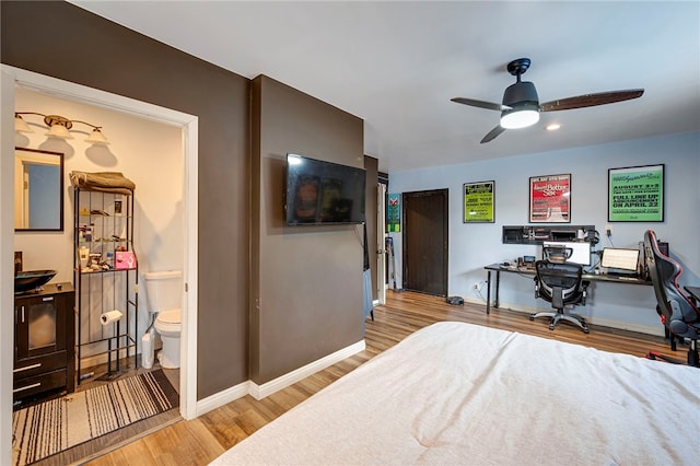 bedroom featuring light hardwood / wood-style floors, ensuite bath, and ceiling fan