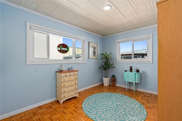 miscellaneous room featuring crown molding, light parquet flooring, and a healthy amount of sunlight