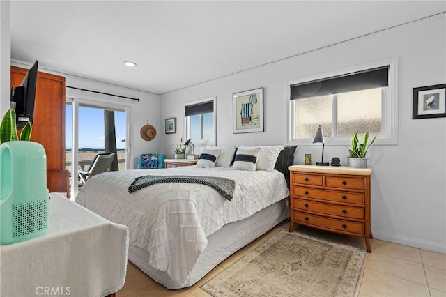 bedroom with multiple windows, access to exterior, and light tile patterned flooring