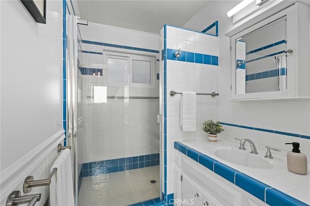 bathroom featuring vanity and a shower with shower door