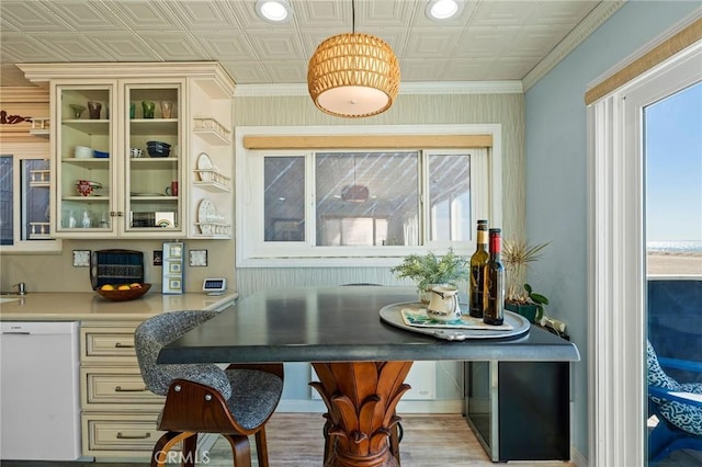 dining space featuring crown molding and plenty of natural light