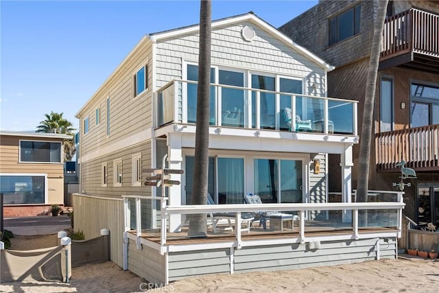 back of property with a balcony