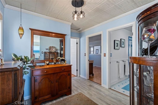 interior space with ornamental molding and light hardwood / wood-style flooring