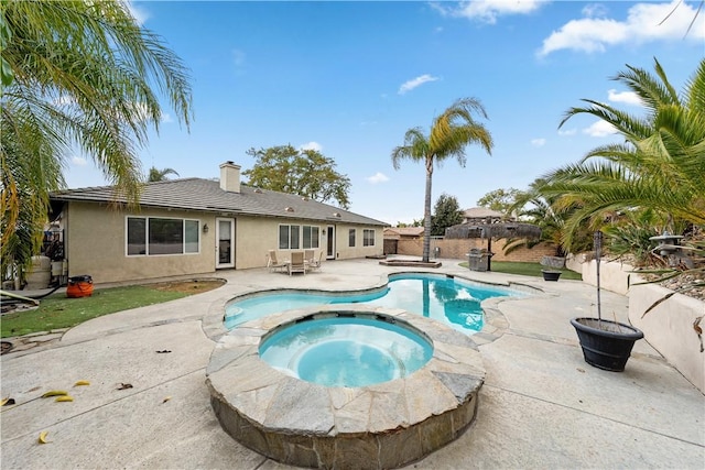 view of pool with an in ground hot tub and a patio