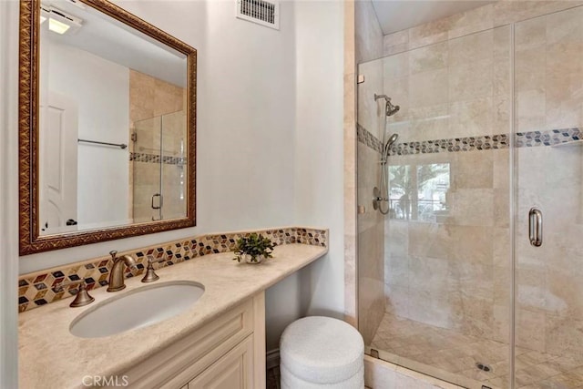 bathroom with tasteful backsplash, vanity, and walk in shower