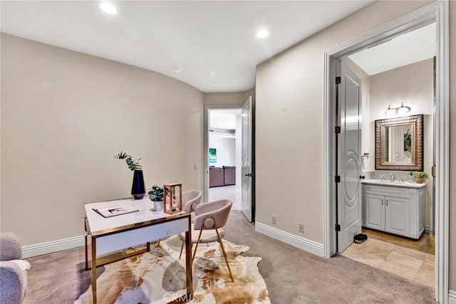 office space with sink and light colored carpet