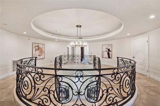interior space with a notable chandelier and a tray ceiling