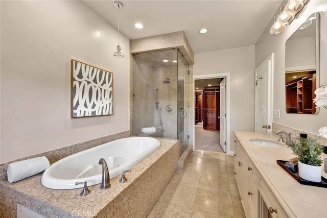 bathroom featuring vanity and shower with separate bathtub