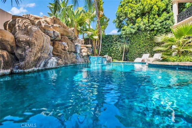 view of pool with pool water feature