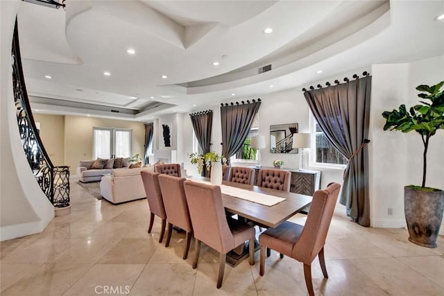 dining space featuring a tray ceiling