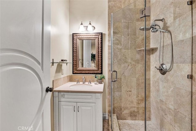bathroom with vanity and a shower with shower door
