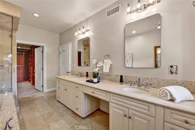 bathroom with vanity, decorative backsplash, and walk in shower