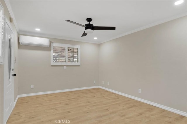 unfurnished room featuring crown molding, a wall unit AC, and light hardwood / wood-style flooring