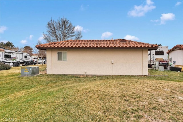 view of side of property with a lawn