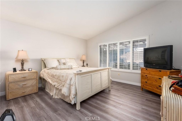 bedroom with dark hardwood / wood-style flooring and vaulted ceiling