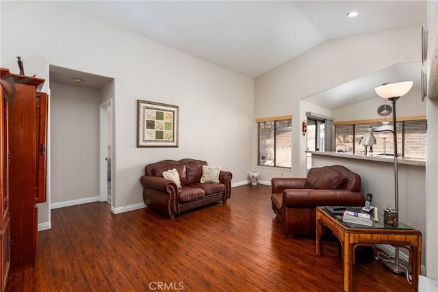 living room featuring dark hardwood / wood-style floors and vaulted ceiling