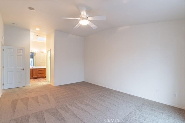 empty room with light colored carpet and ceiling fan