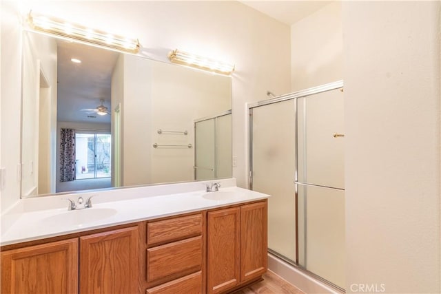 bathroom with vanity and a shower with door