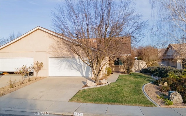 view of front of home featuring a garage and a front lawn