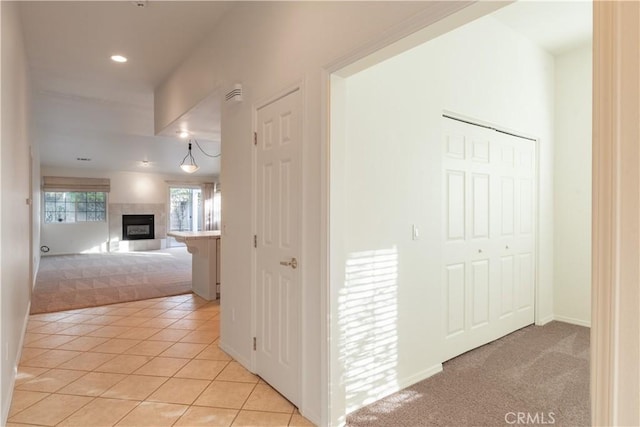 hall featuring light tile patterned flooring