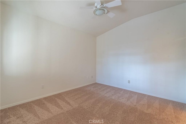 empty room with vaulted ceiling, carpet flooring, and ceiling fan