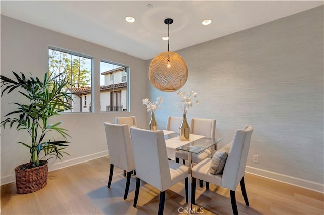 dining space with recessed lighting, baseboards, and wood finished floors