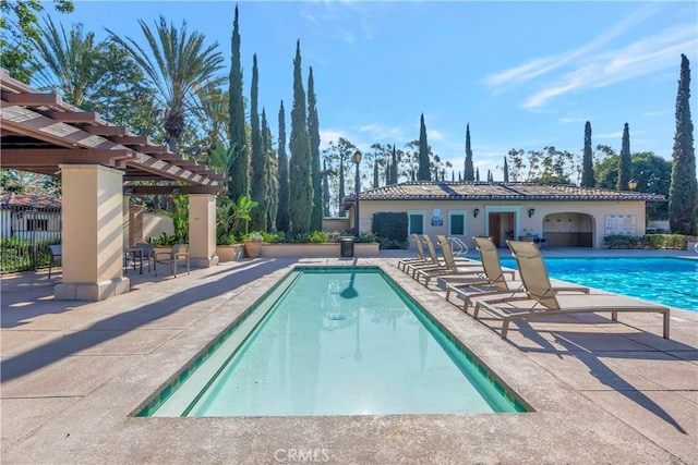 community pool with a patio, fence, and a pergola